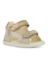 Sandal in beige per bambini con design metallico perforato, cinturino in Velcro regolabile e suola in gomma bianca. Stile open-toe con ritagli laterali.