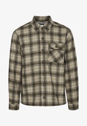 Camicia a quadri in crema, marrone e nero con chiusura a bottoni, colletto a punta e una tasca sul petto. Tessuto morbido e texture.