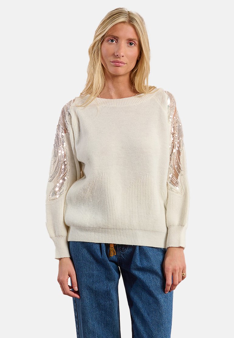 Maglione color crema con maniche lunghe decorato con paillettes, caratterizzato da un orlo a coste testurizzato e una vestibilità morbida. Realizzato in materiale morbido.