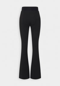 Black flared pants with a smooth, stretchy fabric and an elastic waistband. Features a clean, simple silhouette without pockets.