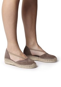 Brown suede espadrilles with braided jute sole, featuring crossed elastic straps for secure fit and a rounded toe design.
