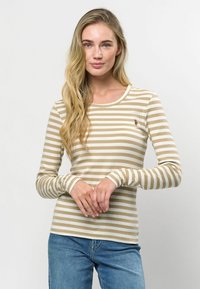 Bēša un baltu svītru garām piedurknēm krekliņš ar ribinātu tekstūru, apaļu kakla izgriezumu un mazām izšūtām detaļām uz krūtīm.