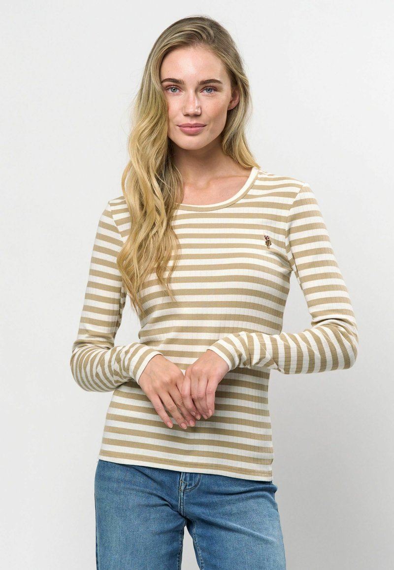 Bēša un baltu svītru garām piedurknēm krekliņš ar ribinātu tekstūru, apaļu kakla izgriezumu un mazām izšūtām detaļām uz krūtīm.