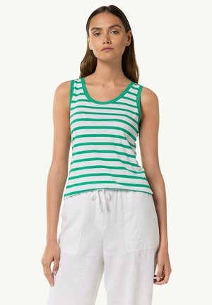 White tank top with green horizontal stripes, rounded neckline, and contrasting trim. Worn with loose-fitting white trousers.