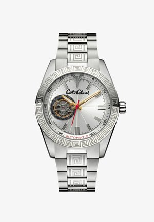 Silver stainless steel watch with a geometric patterned band. Features a round silver face, automatic movement, gold and red accents, and visible gears.