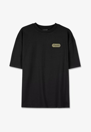 Black short-sleeve t-shirt made from cotton, featuring a rectangular logo patch in beige. Simple round neckline and straight hem.
