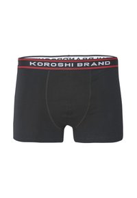 Melnas bokseršortus no gludas auduma, ar elastīgu jostu, uz kuras balta un sarkana krāsā ir uzraksts "KOROSHI BRAND".