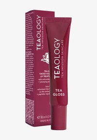 Teaology Tea Gloss in un tubo bordeaux, con una finitura opaca. Accompagnato da una scatola coordinata, con testo bianco e piccoli elementi decorativi.