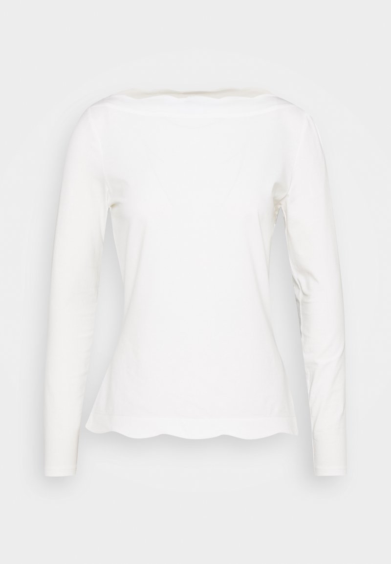 White long-sleeve shirt with scalloped hem and boat neckline, displayed on a plain background.
