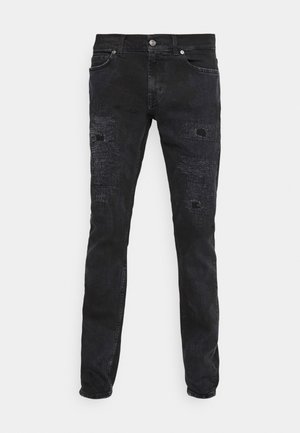 Black denim jeans with a slim fit, featuring distressed patches and a slight sheen. Five-pocket design with metal button and zipper closure.