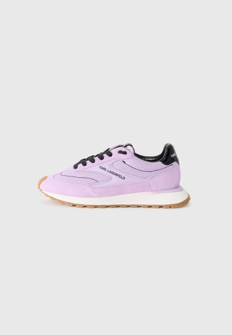 Purple suede sneakers with black accents, featuring round laces, a white midsole, and a textured gum rubber sole. Logo detail on the side.