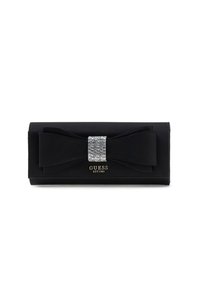 Portafoglio clutch nero con superficie texture, caratterizzato da un grande fiocco e una chiusura decorata con strass. Logo dorato "GUESS EST 1981" nella parte inferiore.