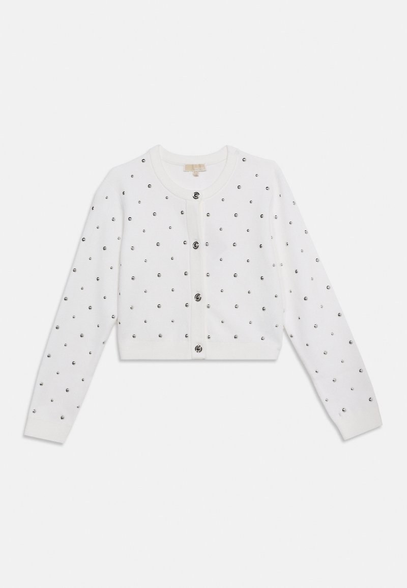 Valge pika varrukaga lühike kardigan ümmarguse kaeluse, esiotsa mustade nööpide ja kogu pinna kaetud väikeste mustade naeltega.