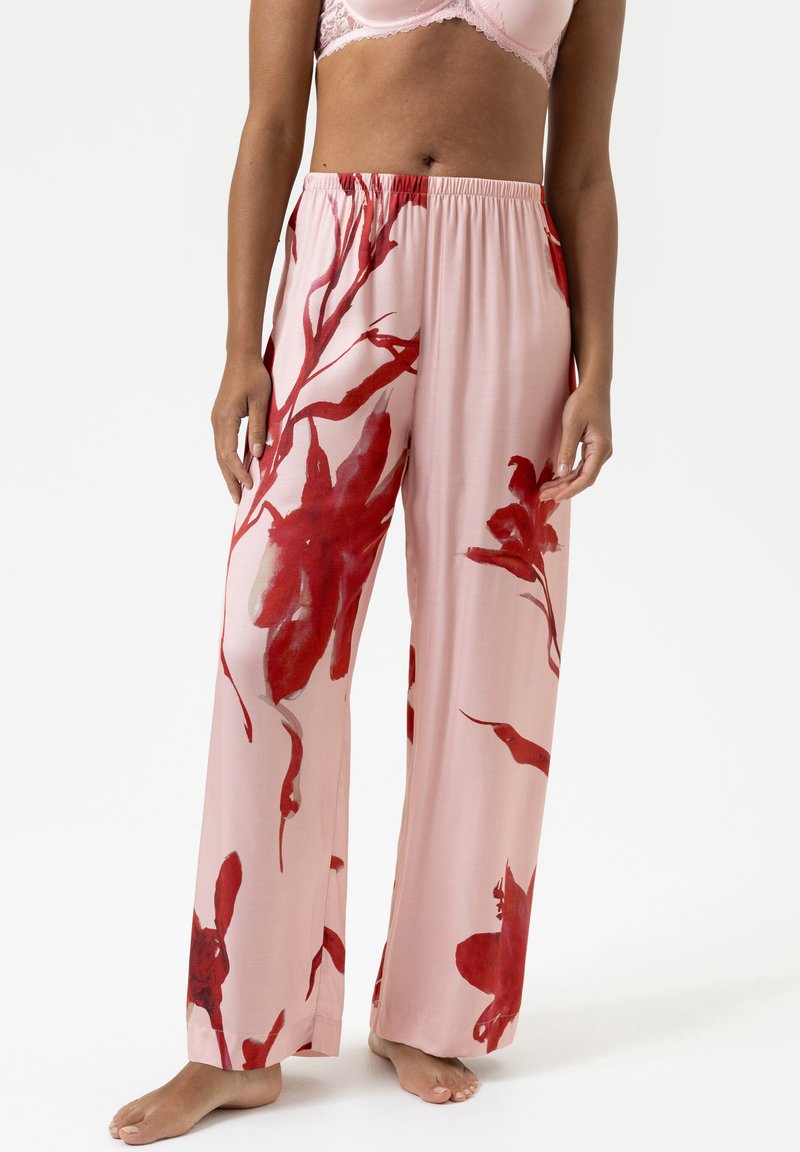 Pantalons floraux roses avec des motifs abstraits rouges, en tissu léger, design à jambes larges et taille élastique. Texture lisse et respirante.