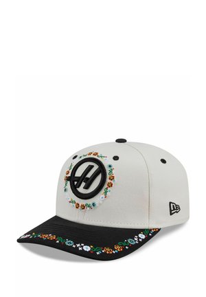 Cap with a light gray body, black bill, and colorful floral embroidery around the front circle logo and along the edge of the bill.