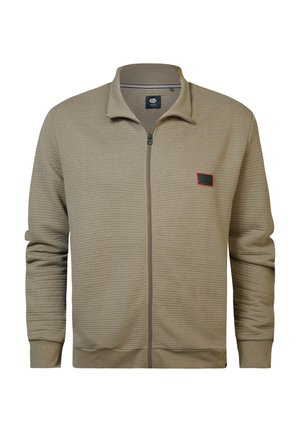 Lysebrun zip-up jakke med struktureret, ribbet stof, kontrasterende rød accentlabel på venstre bryst samt standard krave og manchetter.