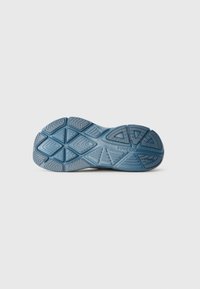 Blue rubber outsole with a textured, geometric pattern, featuring grooves and ridges for traction. Branding visible near the heel area.