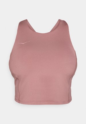Crop top sportivo rosa realizzato in materiale elasticizzato. Presenta un colletto arrotondato e una texture liscia, con un logo sottile nell'angolo superiore.