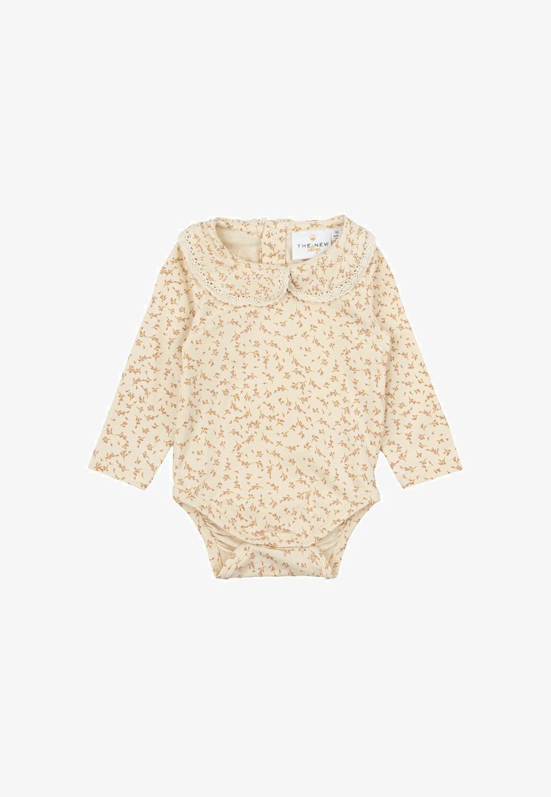 Hosszú ujjú babagatyó krémszínű, apró virágmintával, csipkeborítású gallérral és patentgombokkal az alján. Puha, könnyű anyag.