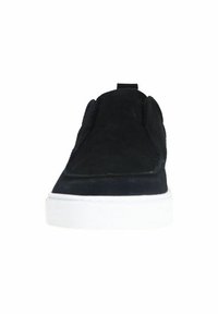 Black suede slip-on shoe with a rounded toe, padded collar, and white rubber sole. Features minimalistic design and no visible hardware.