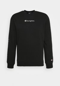 Felpa nera con maniche lunghe, scollo rotondo e logo bianco "Champion" sul petto. Presenta dettagli di marca sulle maniche.
