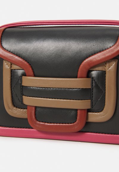 Leather handbag with a black body, featuring red, beige, and brown accents. Notable hardware includes a geometric clasp design.
