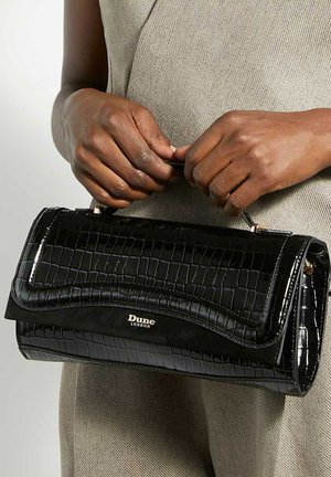 Black patent leather handbag with a crocodile pattern, featuring a wave design on the flap and a gold logo accent.