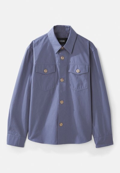 Button-up shirt in slate blue, made of smooth fabric, featuring two chest pockets, gold-tone buttons, and a standard collar.