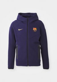 Paarse hoodie van fleece materiaal met een volle rits, zijzakken en een logo van FC Barcelona op de borst. Verstelbare capuchon.