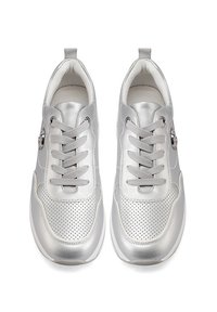 Scarpe da ginnastica argento con una finitura metallica lucida. Presentano dettagli perforati, lacci rotondi e una linguetta per il pull sul tallone.