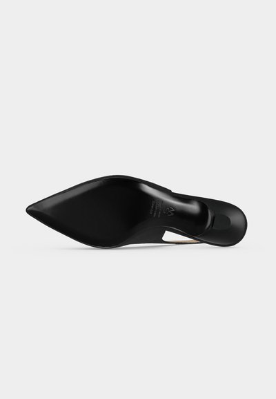 Chaussure à talon haut noire à bout pointu, vue du côté de la semelle sur un fond uni clair. Aucun autre objet ou personne visible.