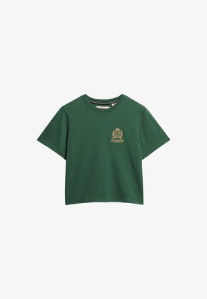 Green cotton t-shirt with a round neckline and short sleeves. Features a small gold logo on the left chest. Soft, smooth texture.