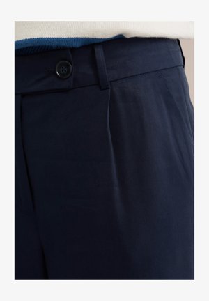 Marineblau Hosen aus glattem Stoff, mit einem Knopfverschluss, gefüttertem Design und tiefen Seitentaschen für zusätzliche Funktionalität.