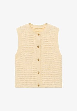 Pletene brezrokavnike iz teksturirane kreme preje, ki ima spredaj gumbasto zapiranje z zlato gumbi in dve majhni našiti žepki.