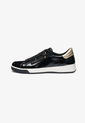 Black shiny sneaker with thick white sole, gold heel accent, black laces, and side zipper detail, viewed from the outer side.
