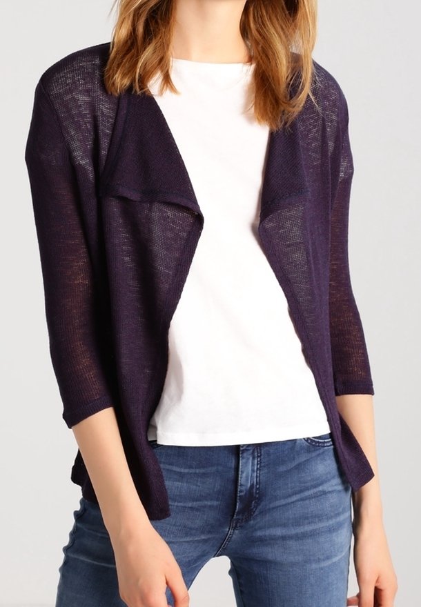 Cardigan leggero, aperto sul davanti, di colore viola scuro, con maniche a tre quarti e motivo a maglia strutturata, indossato sopra una camicia bianca e jeans blu.