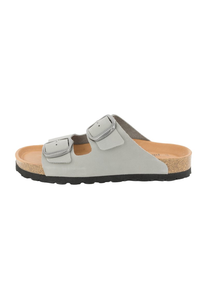 Gray suede slide sandal with two adjustable silver buckles, cork footbed, and black rubber outsole, showcasing a minimal and modern design.