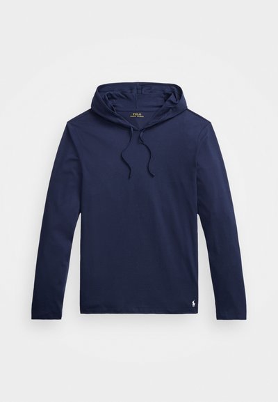 Jūras spēku garām piedurknēm kaklasaite, izgatavota no gludas auduma, ar kapuci un aukliņu. Iezīmē neliels logo apakšmalā un brīva piegriezuma dizains.