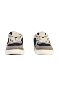 Sneakers with a navy mesh upper, gray suede accents, and white rubber sole. Features round laces and branded tongue detail.