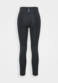 Leggings deportivos negros que presentan una cintura alta, una textura suave y detalles perforados a lo largo de las piernas inferiores para mayor transpirabilidad.