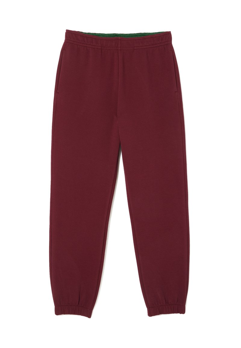 Pantaloni sportivi color bordeaux con una fascia interna verde, dotati di polsini elastici, tasche laterali e un tessuto morbido e strutturato.