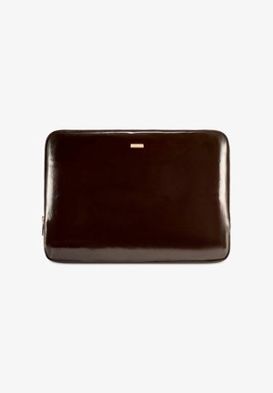 Błyszczący, ciemnobrązowy prostokątny pokrowiec na laptopa z zamkiem błyskawicznym oraz małą metalową metką marki u góry na środku.