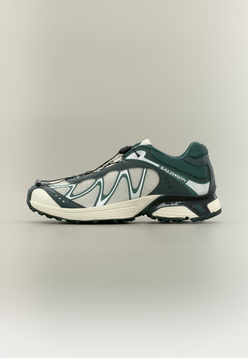 Green and white athletic shoe featuring a mesh upper, textured rubber sole, and a quick-lace system for secure fit.