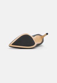 Black pointed-toe high heel with a smooth leather upper, a sleek silhouette, and a beige outsole featuring a rubberized grip.