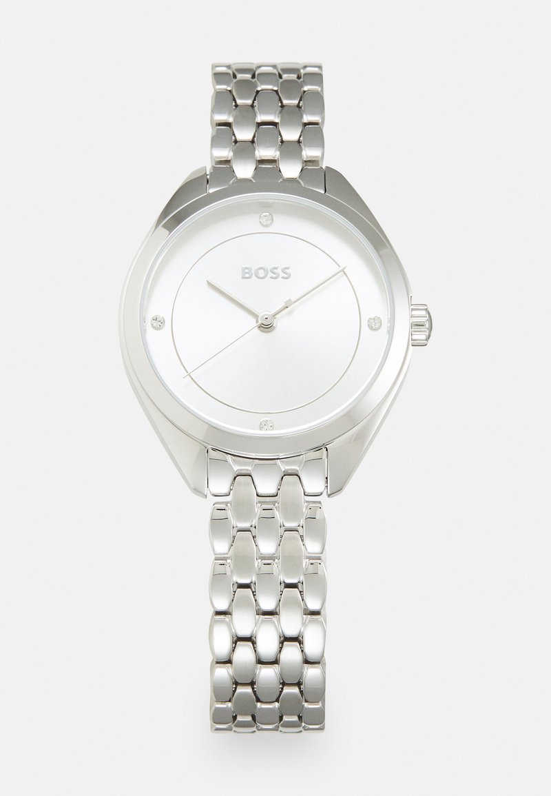 Silver stainless steel watch with a round case, white dial, three hands, and crystal accents. Features a polished link bracelet.