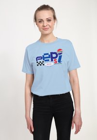 Světle modré bavlněné tričko s multicolor grafickým znakem Pepsi, s kostkovaným vzorem, kulatým výstřihem a krátkými rukávy.