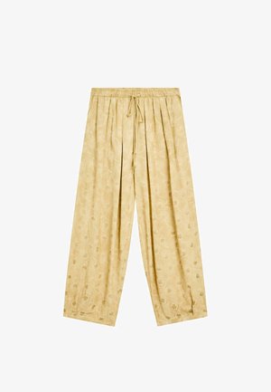 Pantalons larges jaune clair avec une taille élastique et un cordon de serrage, ornés d'un motif floral subtil sur l'ensemble du tissu.