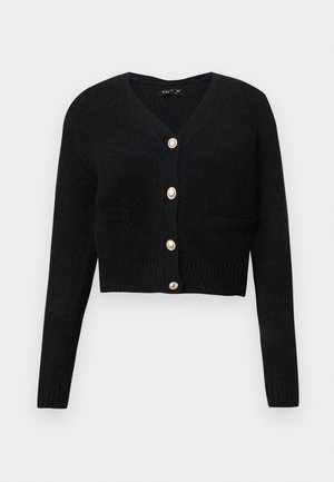 Cardigan noir court en tricot texturé, avec un col en V, des manches longues et six boutons dorés sur le devant.