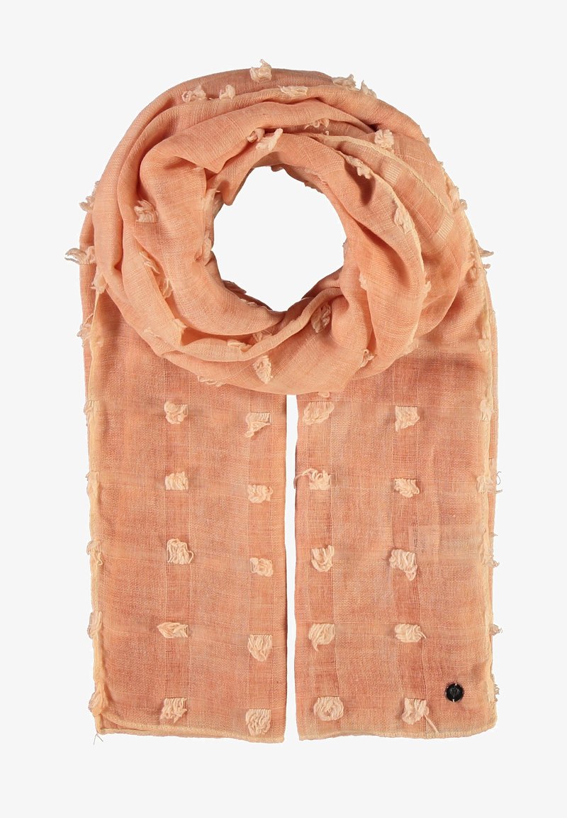 Heled õunakõrvitsa sall, mis on valmistatud tekstureeritud kangast, millel on kudumismustrid ja väikesed dekoratiivsed õied. Ühel lõpus on väike must silt.