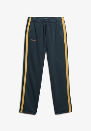 Mørkeblå sweatpants lavet af blødt stof med gule sidelister. Har to forlommer og et broderet logo på venstre side.